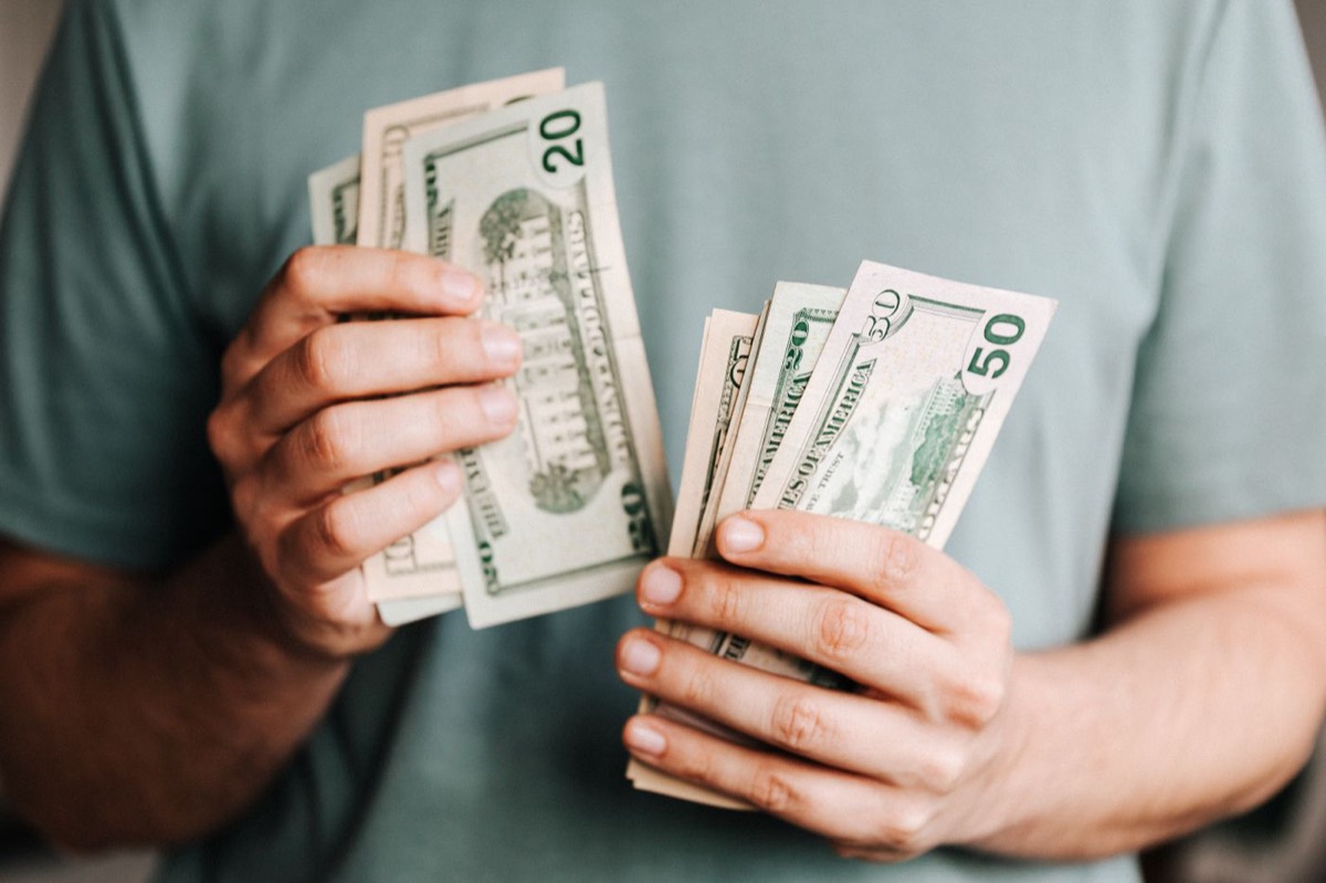 A person counting cash in hand